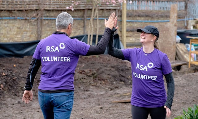 employee volunteers from RSA high-fiving 